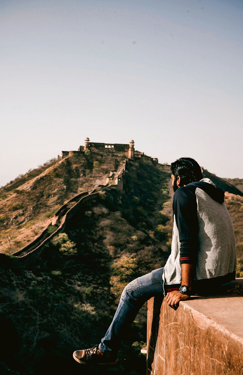 Traveler looking thoughtfully at a historic stone valley