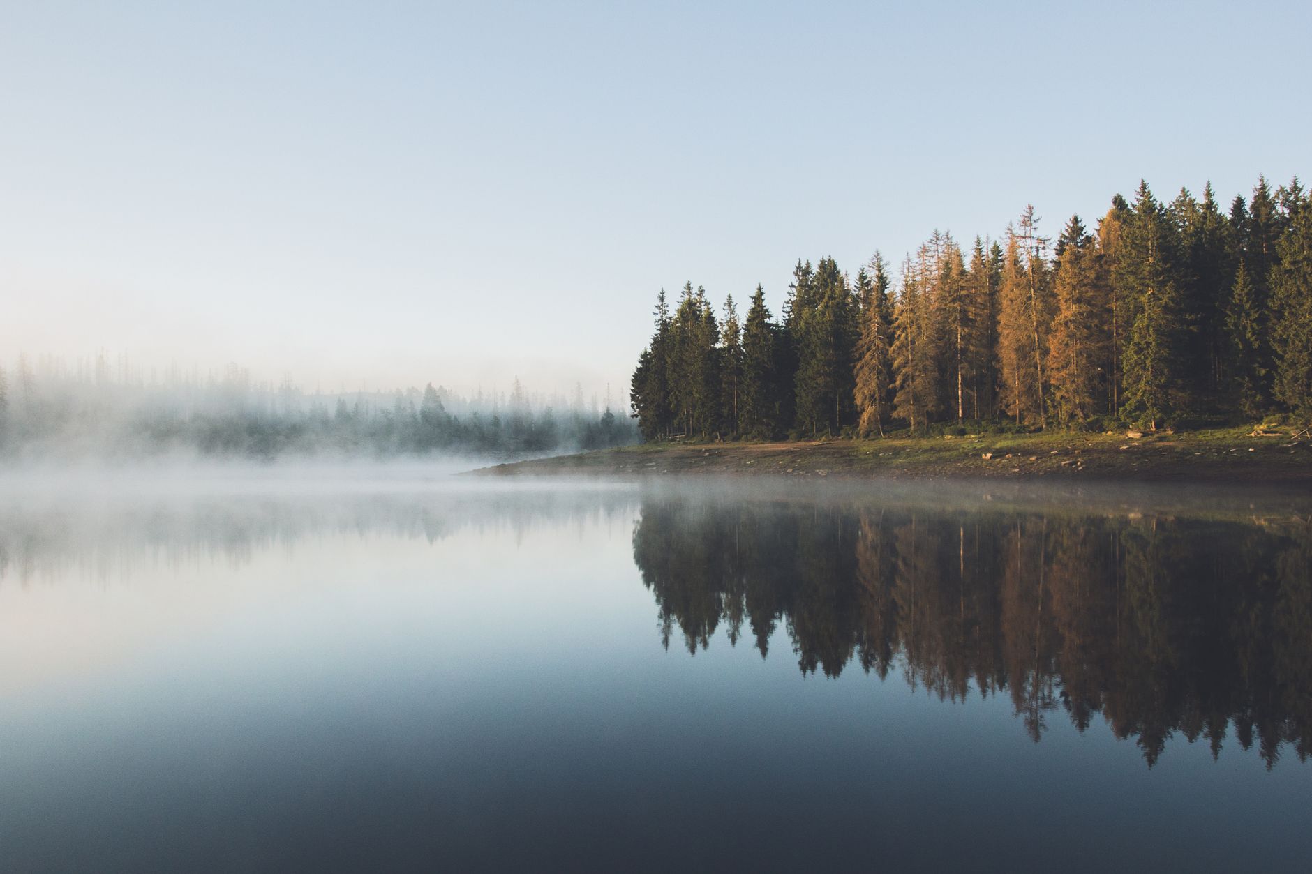 Quiet mist over mountain lake at dawn